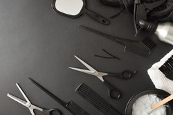 Set of hairdressing tools and styling on black table. Top view. Horizontal composition. 