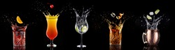 fruit falling into a collection of splashing cocktails isolated on black background
