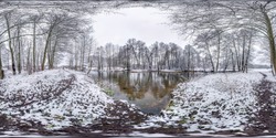 Winter full spherical seamless hdri panorama 360 degrees angle view on road in a snowy park near small river in equirectangular projection. VR AR content