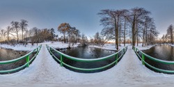 full winter seamless spherical hdri panorama 360 degrees  angle view on wooden bridge over small river in snowy forest in equirectangular projection, VR AR content. 