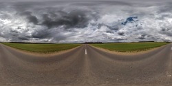 Full spherical seamless panorama 360 degree angle view on no traffic old asphalt road among fields with dark overcast sky before storm in equirectangular projection, VR AR content