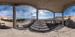 full seamless spherical hdr panorama 360 degrees in carcass of abandoned concrete unfinished building with columns and stairs on the seashore in desert in equirectangular projection. VR AR concept