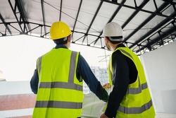 Civil Engineer and Construction Supervisor inspect the internal construction of building at construction site. Constructions engineer or architect and Foreman inspect the construction inside building.