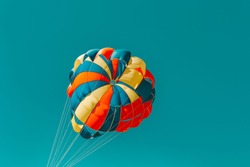Parachute parasailing of tourists on a sandy beach Sunny weather against the background of clear sea and ocean.The wind blows up the canopy of the parachute against a clear blue sky with clouds