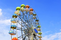 Ferris wheel on the background of blue sky 