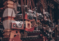 vintage cameras at flea market. Collection of retro-film analog cameras. many kinds of different model old photo cameras in a street store.