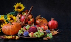 Candle, fruits, pumpkins, flowers on black background. Wiccan altar for Mabon sabbat. autumn equinox holiday. Witchcraft, esoteric spiritual ritual