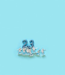 23 number and plastic toys soldiers on abstract blue background. February 23 Holiday, Fatherland defender men's day concept. greeting card minimal design. flat lay. copy space