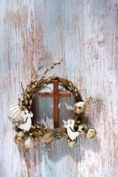 pussy willow wreath, eggs, cross and decorative angels on rustic wooden background. Easter, Palm Sunday holiday. prayer, faith, spiritual life, orthodox Church, religion concept. flat lay