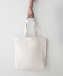 Blank canvas tote bag, design mockup with hand. Handmade shopping bags.