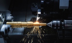 Metal machine tools industry. CNC turning machine high-speed cutting is operation.flying sparks of metalworking