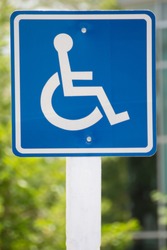 Blue wheelchair sign on the post