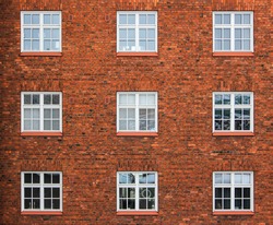 Old red brick wall with windows in Helsinki, Finland
