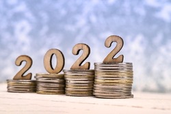 Coins and Figures 2022. Banner 2022. Money stacked in columns.