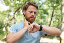 runner looking at wearable sportwatch smart watch