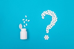 Question Mark Made from White Pills and Tablets with Pill Container, Lying on Blue Background. Global Pharmaceutical Industry and Medicinal Products