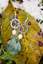 Earrings with burdock leaves and river white pearls