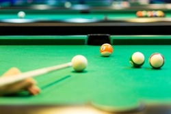 Sport, recreation, game, competition - Playing billiard. Billiards balls an cue on billiards table. Billiard sport concept. Pool billiard game.