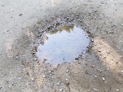 water puddle with mud and pebbles or rocks