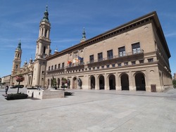 Town hall and cathedral our Lady of Pillar in european Saragossa city at Aragon in Spain, clear blue sky in 2019 warm sunny summer day on September.