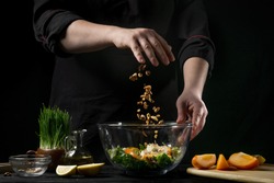 Freezer food prepare in process vegetarian salad by chef hand in home kitchen. Dark black background with Text area for design menu restaurant