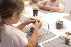 A child sculpts a souvenir from clay. Summer master classes, recreation