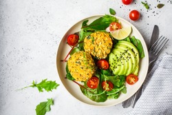 Vegan vegetable burgers with salad in a white plate, copy space.