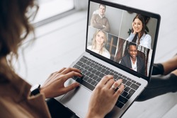 Online business meeting. Business team working from home in a video conference. The girl communicates via video call communication using laptop with her business colleagues about the future strategy