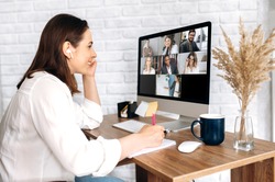 Video call. Remote work. A girl work from home. She communicate via video communication with colleagues using computer