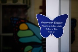 Butterfly shaped blue sign stating, 