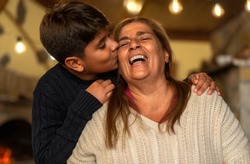 Happy smiling Hispanic grandmother and his grandchild having tender moment together - Family love and unity concept 