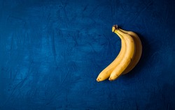 bunch of bananas on a dark blue background