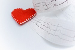 Cardiogram paper tape on a table with a red heart. Cardiogram of the heart. Your text