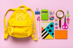Frame from school and office supplies Paper clips, scissors, pens, felt-tip pens, sharpener, calculator, stapler isolated on pink background Flat lay Top view Back to school, education concept Mock up