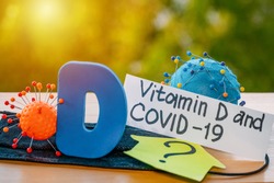 Vitamin D help in treating coronavirus. Vitamin D, coronavirus and question mark on a background of sunlight.