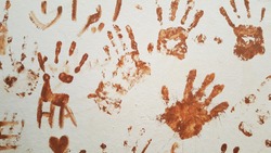brown handprints on the wall. imprint fingerprints  background.  