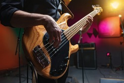 bass guitar in hands of musician