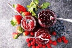 assortment of jams, seasonal berries, mint and fruits 