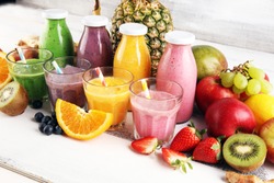 Assortment of fruit smoothies in glass bottles. Fresh organic Smoothie ingredients. Smoothies for health or detox diet food concept.
