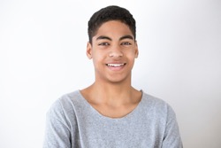 Smiling and happy black young man on white background. Portrait of a cheerful African American boy, teenager, student.