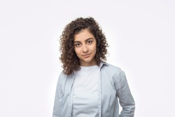 Portrait of an attractive Indian young woman on a white background. A mixed race girl is looking at the camera.
