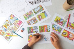 Drawing a colored storyboard. The illustrator creates comics on paper.