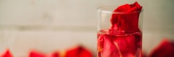 Banner Rose petals in a bowl of water
