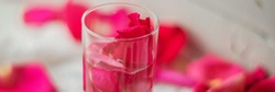 Banner Rose petals in a bowl of water