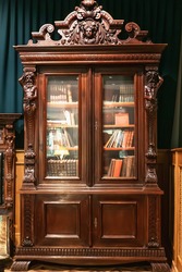 Old antique vintage wooden bookcase with books.