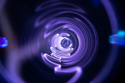 Plasma tunnel and violet electric flashes as abstract futuristic neon background