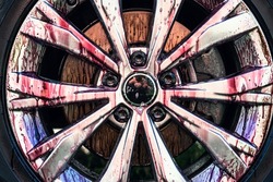Car wheel cleaning process. Rim cleaner gives purple chemical reaction when removing metal or iron inclusions and brake dust. Detailing car wash