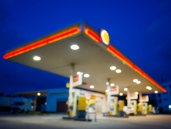 abstract blurred of gas station or petrol station with dark blue sky during twilight time