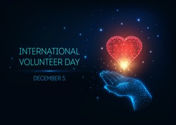 Futuristic glowing low polygonal International Volunteer Day concept with hand holding red heart and text on dark blue background. Modern wire frame mesh design vector illustration.