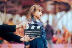 
Little Talented Actress Performing in front of a Camera. Young professional actor filming a scene on set
